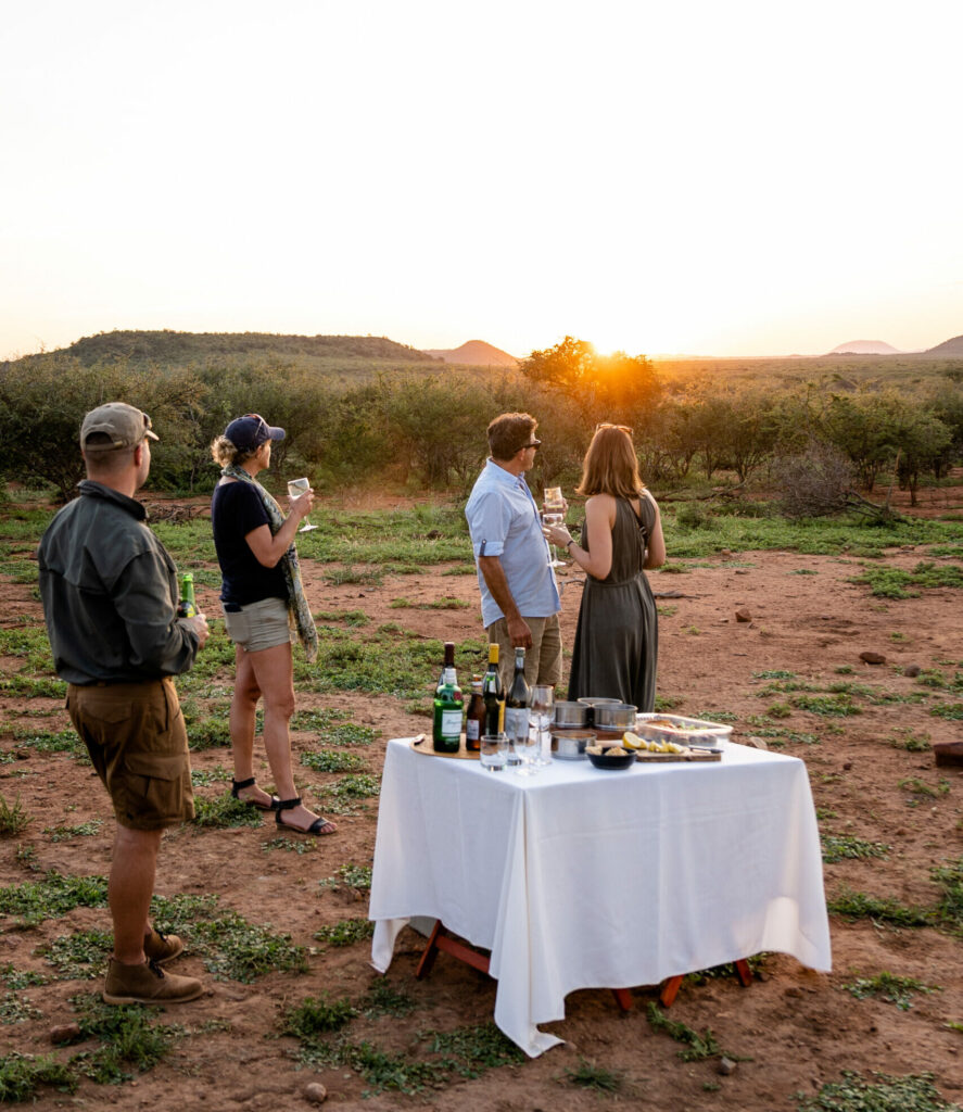 Group enjoying wine at sunset