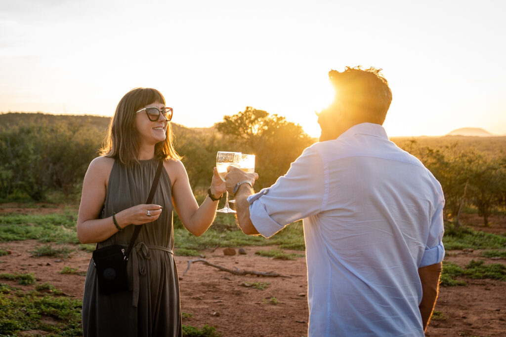 couple having sunset drinks on honeymoon safari in Africa